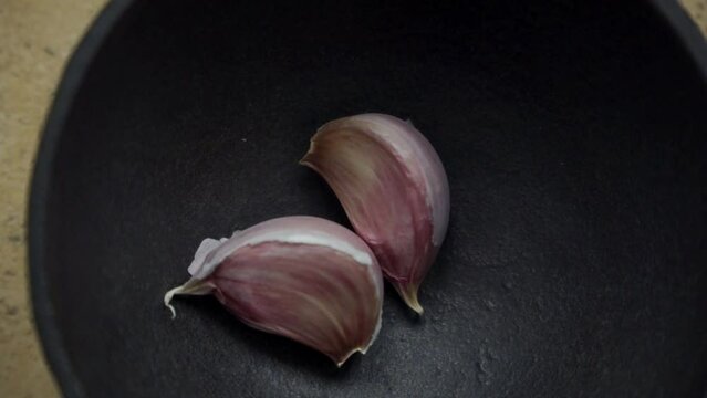 Metal mortar with crushed garlic in the kitchen. (2)