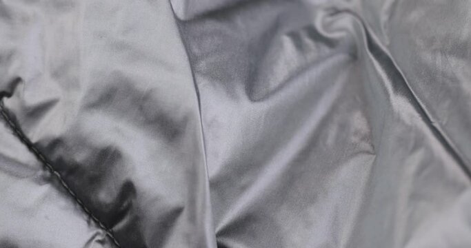 crumpled gray material in close-up, part of the fabric from gray-tinged clothing