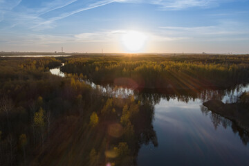 Naklejka na ściany i meble Beautiful sunset on a forest river in summer, view from a height.