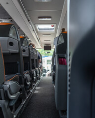 Inside the interior of a bus with rows of passenger seats, bus tourist travel, vertical shot © Oleksandr Bochkala
