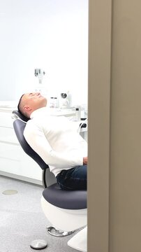 latest technologies in dentistry electronically opening the door the camera comes takes a picture of the patient dental chair peels around white color 