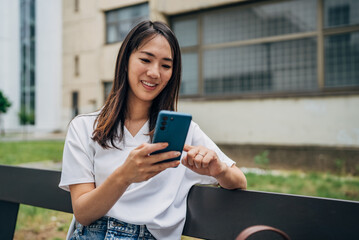 Young Japanese woman using smart phone in the city

