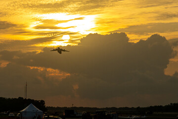 The huge cargo plane flies to the sunset.
