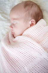 Baby, closeup and sleeping on bed, blanket and tired in profile in family home for growth, peace and comfort. Newborn infant girl, exhausted and childhood development in nursery, bedroom and house