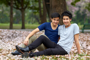 Asian, gay and men in park, portrait of couple on nature date and life together with homosexual, pride and happiness. Young male people relax outdoor in Korea, LGBT and romance, relationship and love