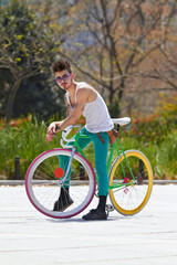Cool man, fashion and portrait with bicycle in city, outdoor and in sunshine with unique personality. Young gen z guy, funky trend and hipster cycling on bike in summer, urban town and with attitude