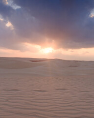 Sunrise over the tranquil Zahek Dunes in Socotra, Yemen, with soft light illuminating the sand.