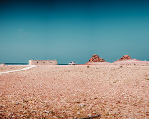 Remote campsite with stone hut and rocky terrain in Dihamri, Socotra, Yemen.

