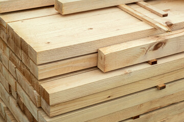 Naklejka na ściany i meble Wood planks stock on construction site. selective focus. lumbers