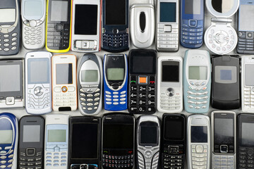 A Heap of old used mobile phones with keyboards. Saved Personal data in a lot of Communication...