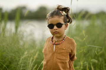 little girl playing by the river in the park