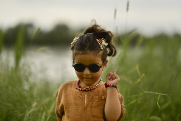 little girl playing by the river in the park