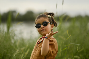 little girl playing by the river in the park