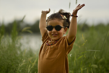 little girl playing by the river in the park