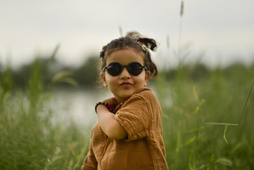 little girl playing by the river in the park