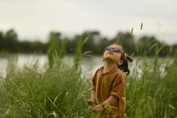 little girl playing by the river in the park