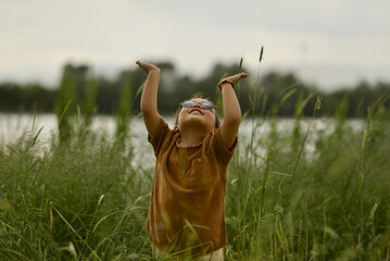 little girl playing by the river in the park