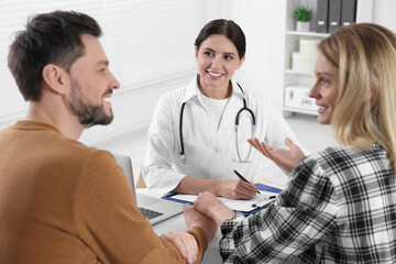 Couple having appointment with fertility doctor in clinic. Patient consultation