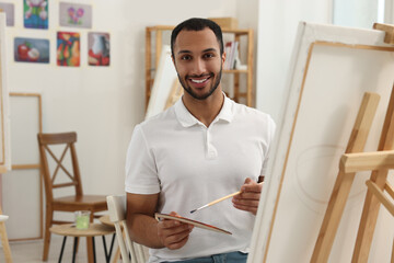 Young man painting in studio. Creative hobby