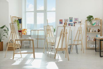 Stylish artist's studio interior with easels and canvases. Creative hobby