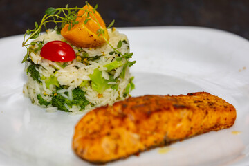 Chic plate of grilled salmon with broccoli rice garnished with fine herbs. real food
