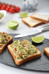Delicious sandwiches with guacamole on white table, closeup