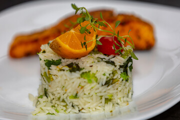 Chic plate of grilled salmon with broccoli rice garnished with fine herbs. real food