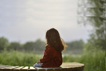 little girl playing and having fun by the river