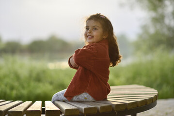 little girl playing and having fun by the river