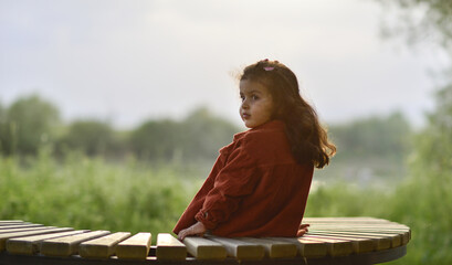 little girl playing and having fun by the river