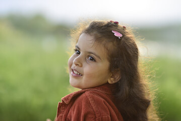 little girl playing and having fun by the river