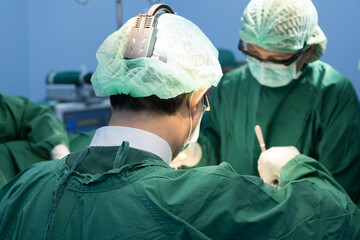 Medical team of surgeons in hospital working surgical intervention.Surgery operating room with...