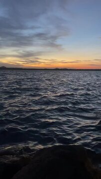  sunset in 'Parakrama Samudraya' Sri Lanka during the windy season. rhythmic water waves. tourist destination. 