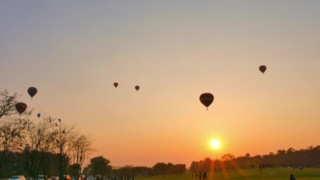 .Chiang Rai,Thailand - February 18,2018:sweet sunrise on the back of .colorful hot air balloons festival at Singha Park in Chiang Rai. .scenery sunrise flying colorful ballon background.