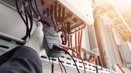 Checking and measuring power cable lines in solar panel. With shiny light.