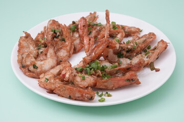 Fried prawn on plate with spring onion