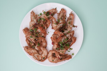 Fried prawn on plate with spring onion