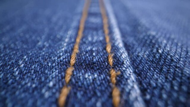 The structure of the fabric. Close-up of blue denim fabric. Dolly shot
