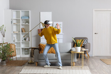 Pretty young woman in VR glasses at home