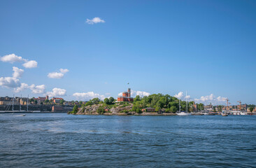 Fototapeta premium The inner harbor in the bay Ladugårdslandsviken, the castell on the island Kastellholmen, a sunny summer morning in Stockholm