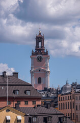Old houses and the tower of the church Storkyrkan, a sunny summer day in Stockholm