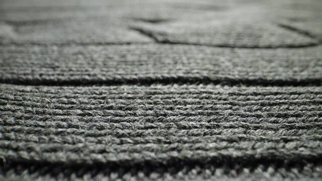The structure of the fabric. Close-up of knitted cotton fabric. Dolly shot