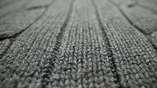 The structure of the fabric. Close-up of knitted cotton fabric. Dolly shot