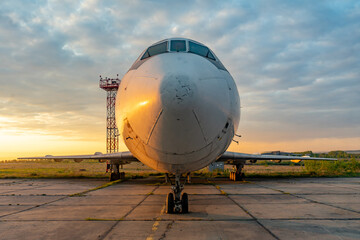 Aircraft on the tarmac of the airport at sunset in the evening