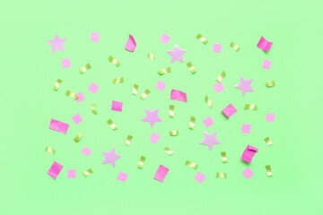 Confetti and stars on green background