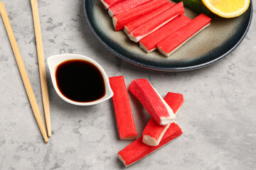 Tasty crab sticks with sauce on grunge background © Pixel-Shot