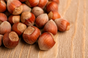 Shelled hazelnuts on wooden background