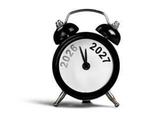 Black alarm clock on with number year. New year concept.