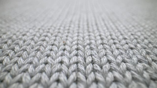 The structure of the fabric. Close-up of knitted cotton fabric. Dolly shot