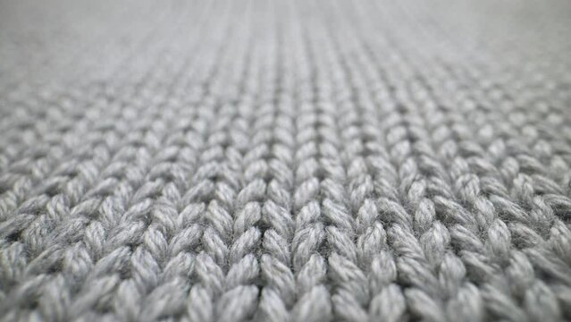 The structure of the fabric. Close-up of knitted cotton fabric. Dolly shot
